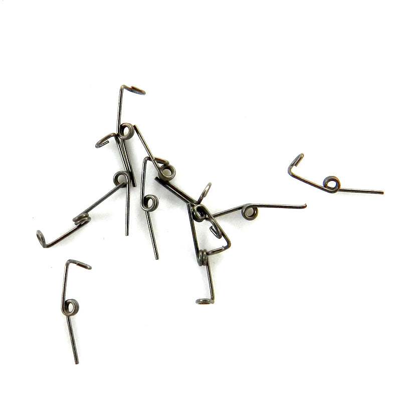 A.J. Wilcock AJW Mini Springs Supreme 0.010” LL short clockwise begg & accessories for watch repair, close-up of spring coil.