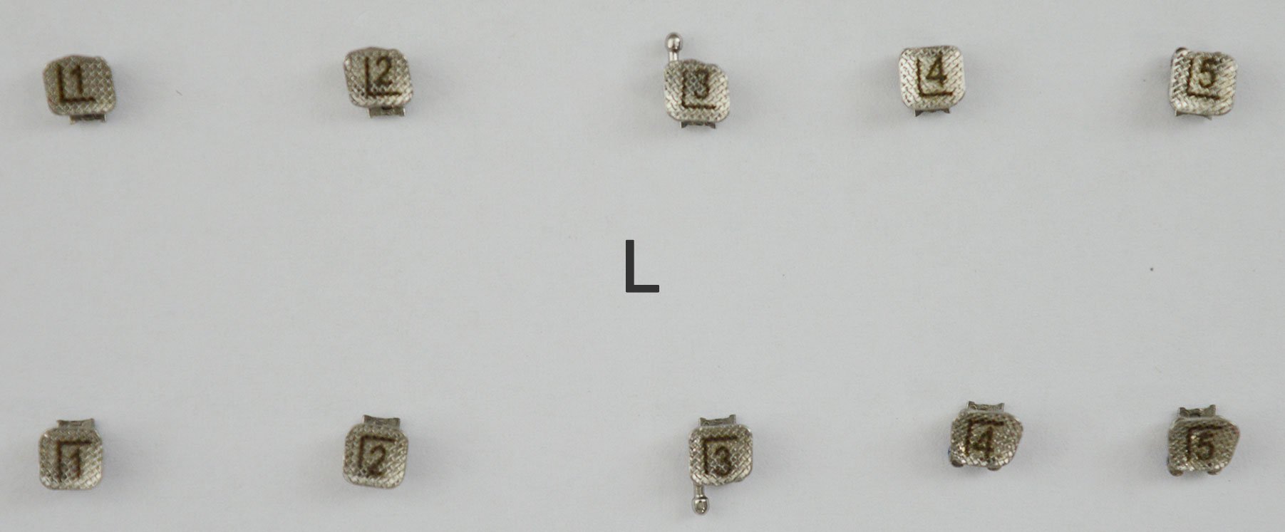 Set of 20 Accel passive self-ligating brackets MBT .022 kit, showing the orthodontic brackets with metal clips and slots for braces.