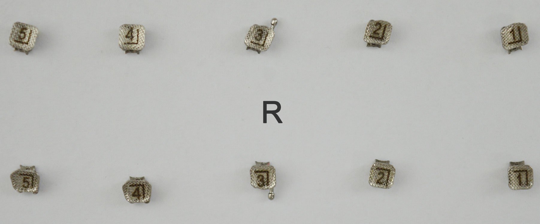 Set of 20 Accel passive self-ligating brackets MBT .022 kits, showing dental brackets with clip mechanisms for orthodontic treatment.