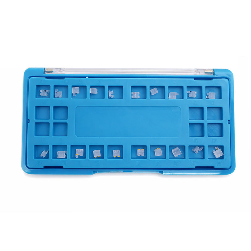 Axim ceramic aesthetic brackets for orthodontic treatment, Roth and MBT style, shown in a kit of 20 clear brackets.