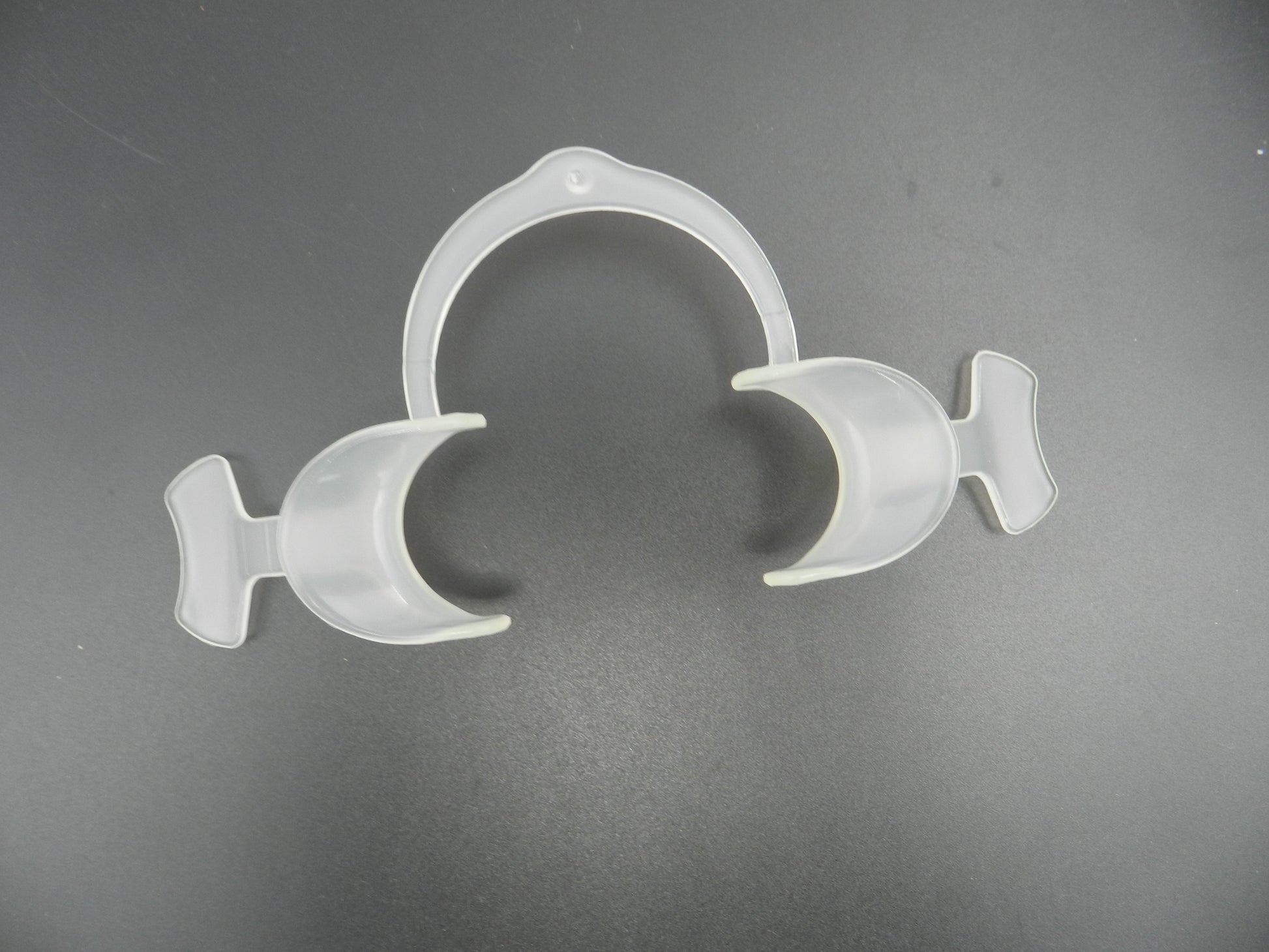 Captain Orthodontics Captain Flexi Eco cheek and tongue retractor with wings, medical dental instrument for oral procedures.