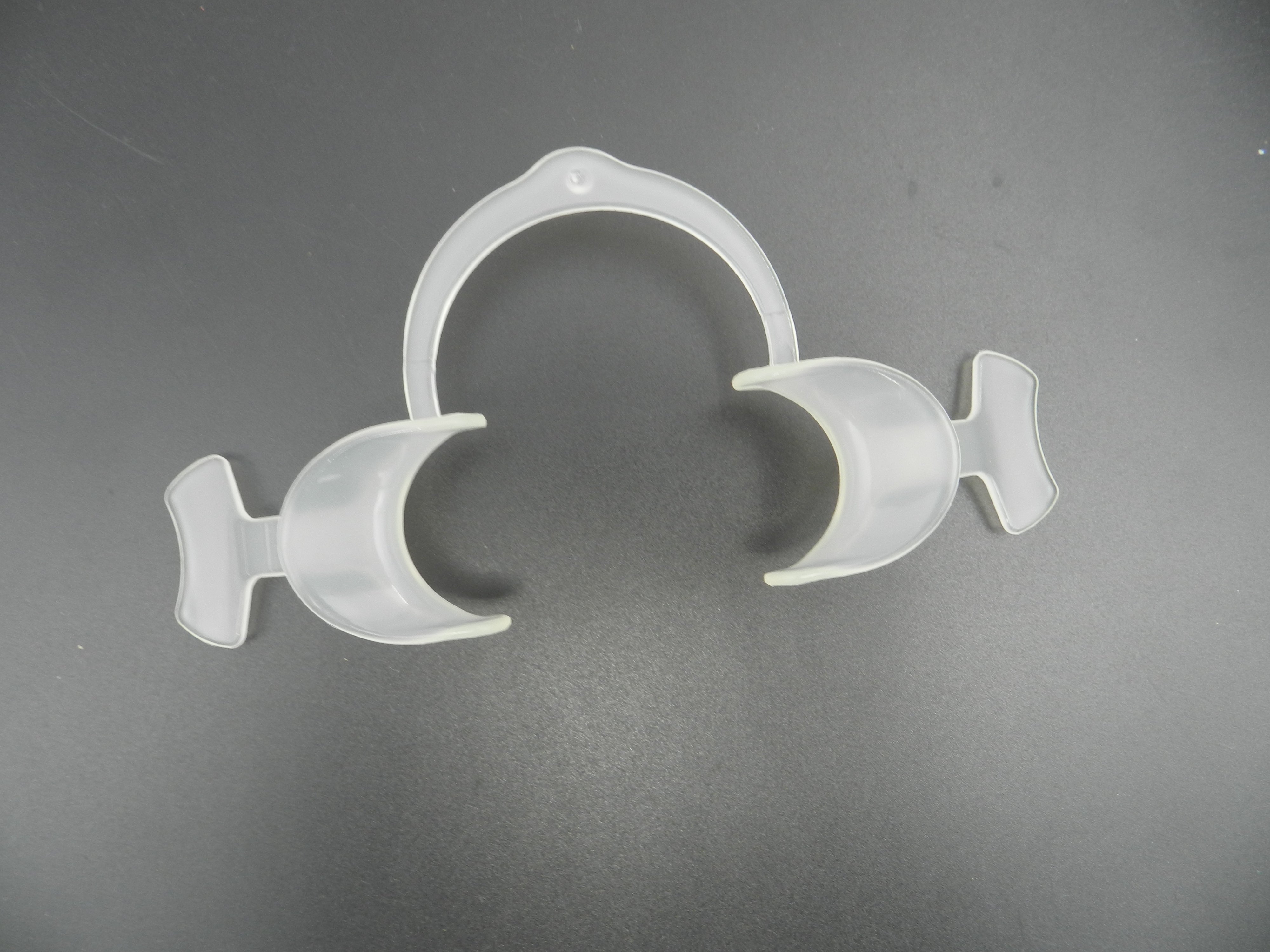 Captain Orthodontics Captain Flexi Eco cheek and tongue retractor with wings, medical dental instrument for oral procedures.