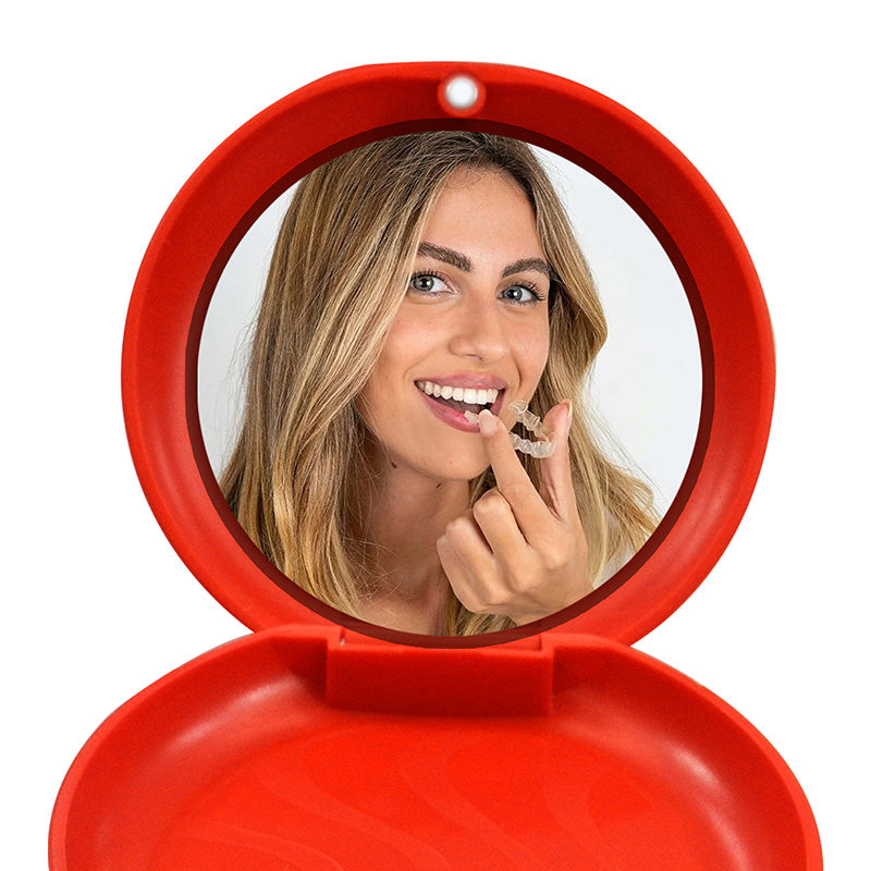 Red Captain Slim Aligner Case with silicone layer for dentures and retainers, by Captain Orthodontics, shown open with aligners inside.