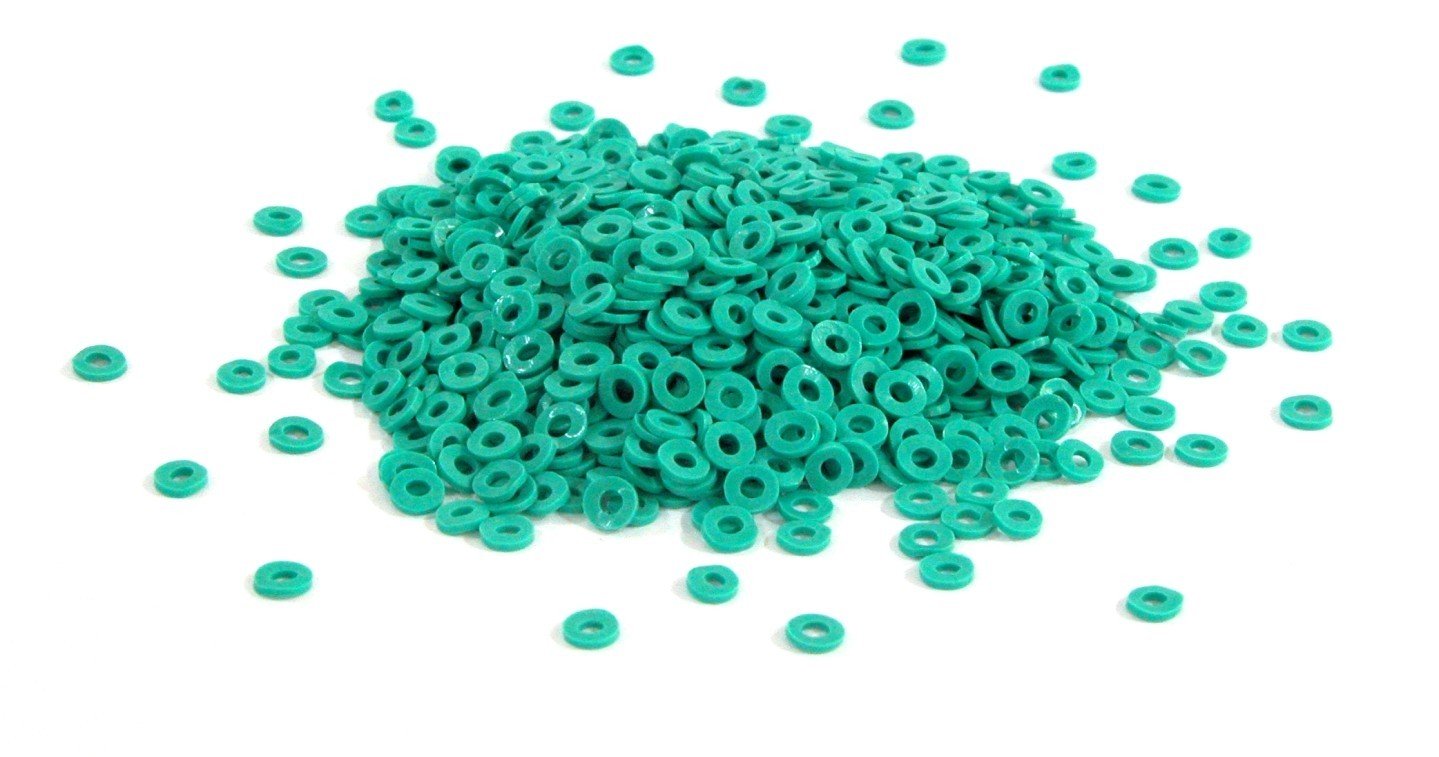 Green Captain Orthodontics loose separators for orthodontic treatment, shown in a close-up image.