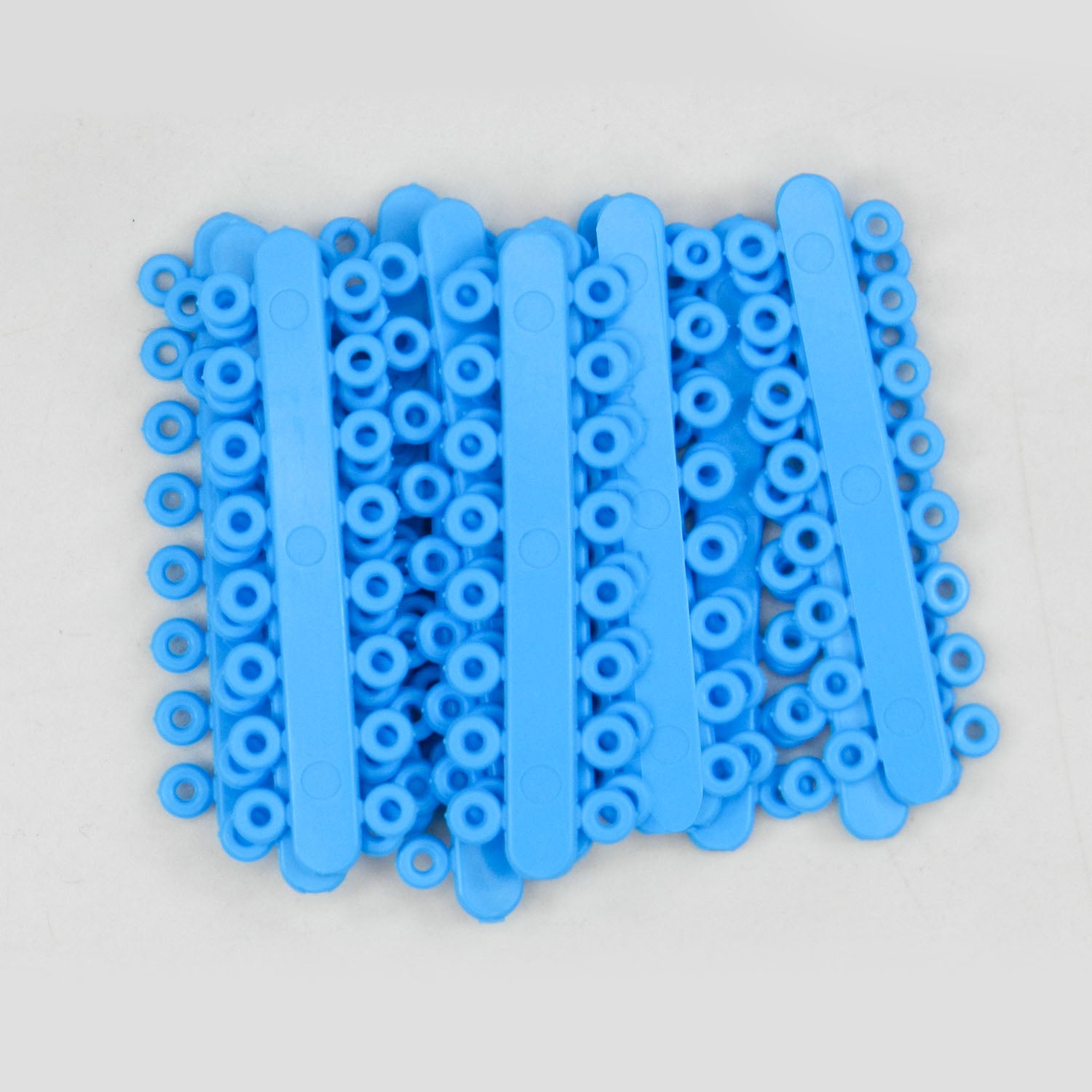 Large green Captain RO Sticks Separators by Captain Orthodontics, used for spacing in orthodontic procedures.