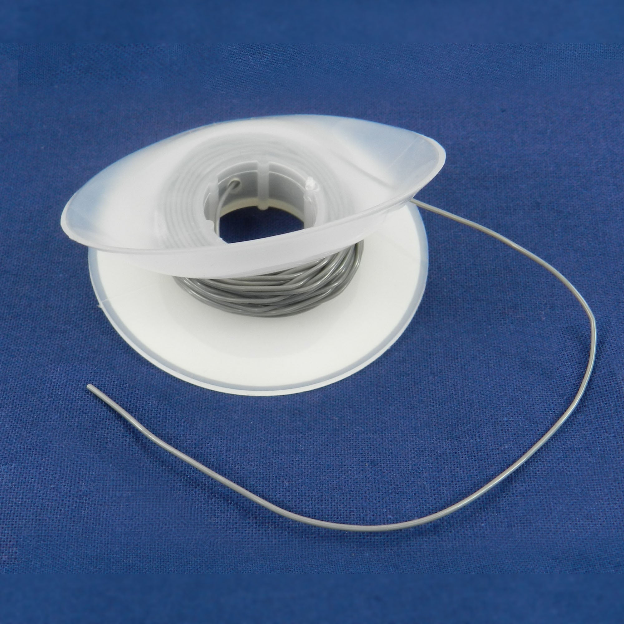 Grey Captain Solid Elastic Power Thread .025 inch for orthodontic use, shown with sleeve and thread in a close-up image.