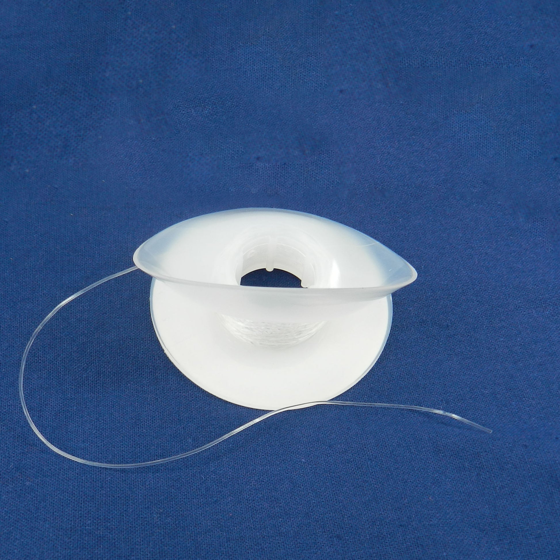 Gray Captain Orthodontics solid elastic power thread sleeve and thread, .025 inch diameter for orthodontic applications.