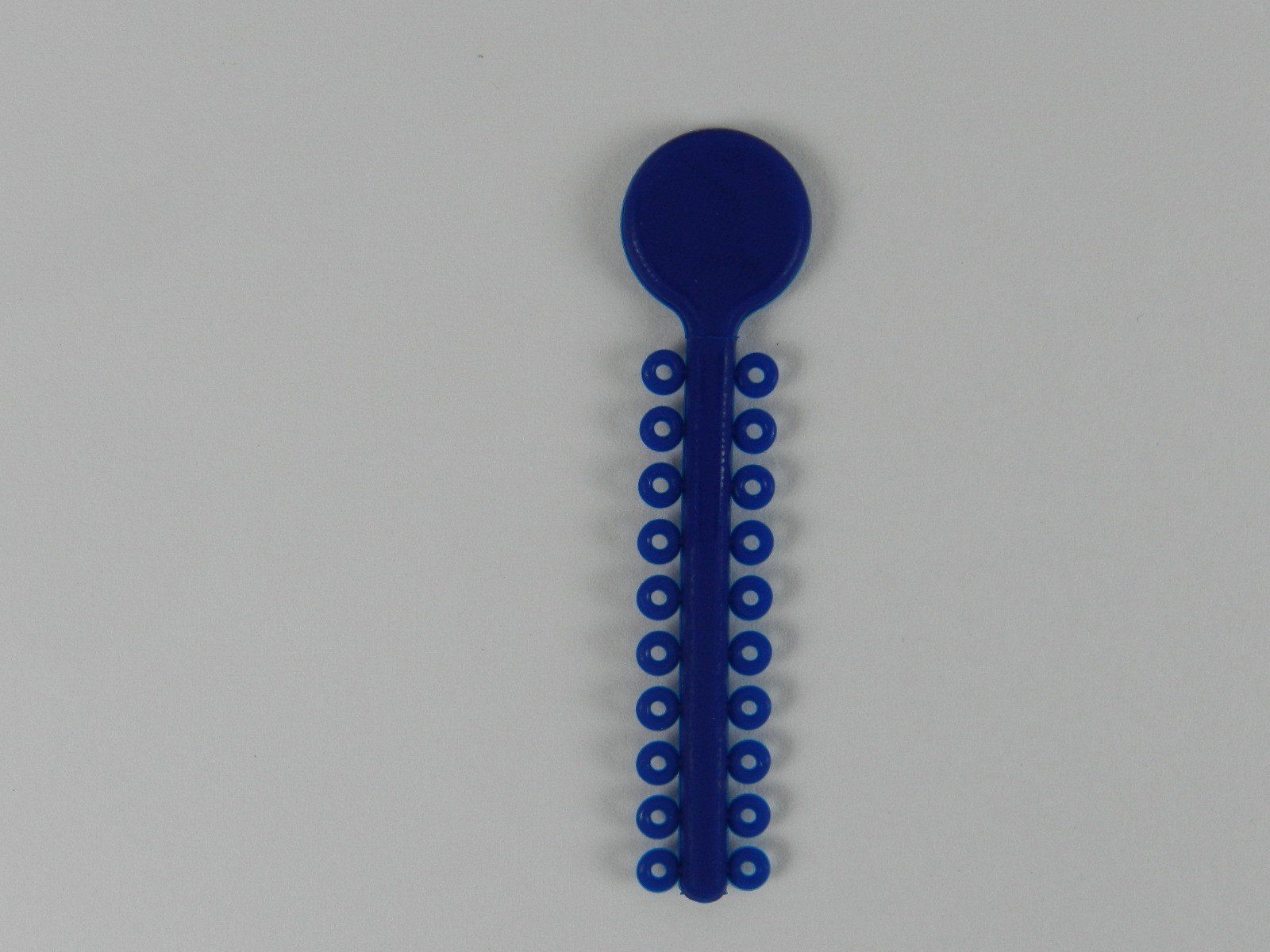 White G&H Select Elastomeric Ligature Ties used in orthodontic braces, shown in a pack of 1000.