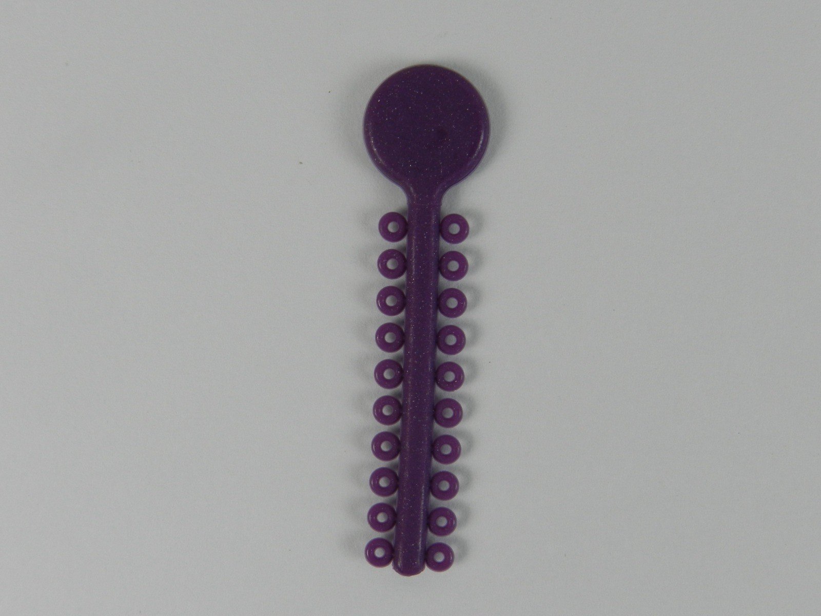 G&H Ortho G&H Select Elastomeric Ligature Ties in white, 1000-pack for orthodontic braces, showing close-up of flexible ligature ties.