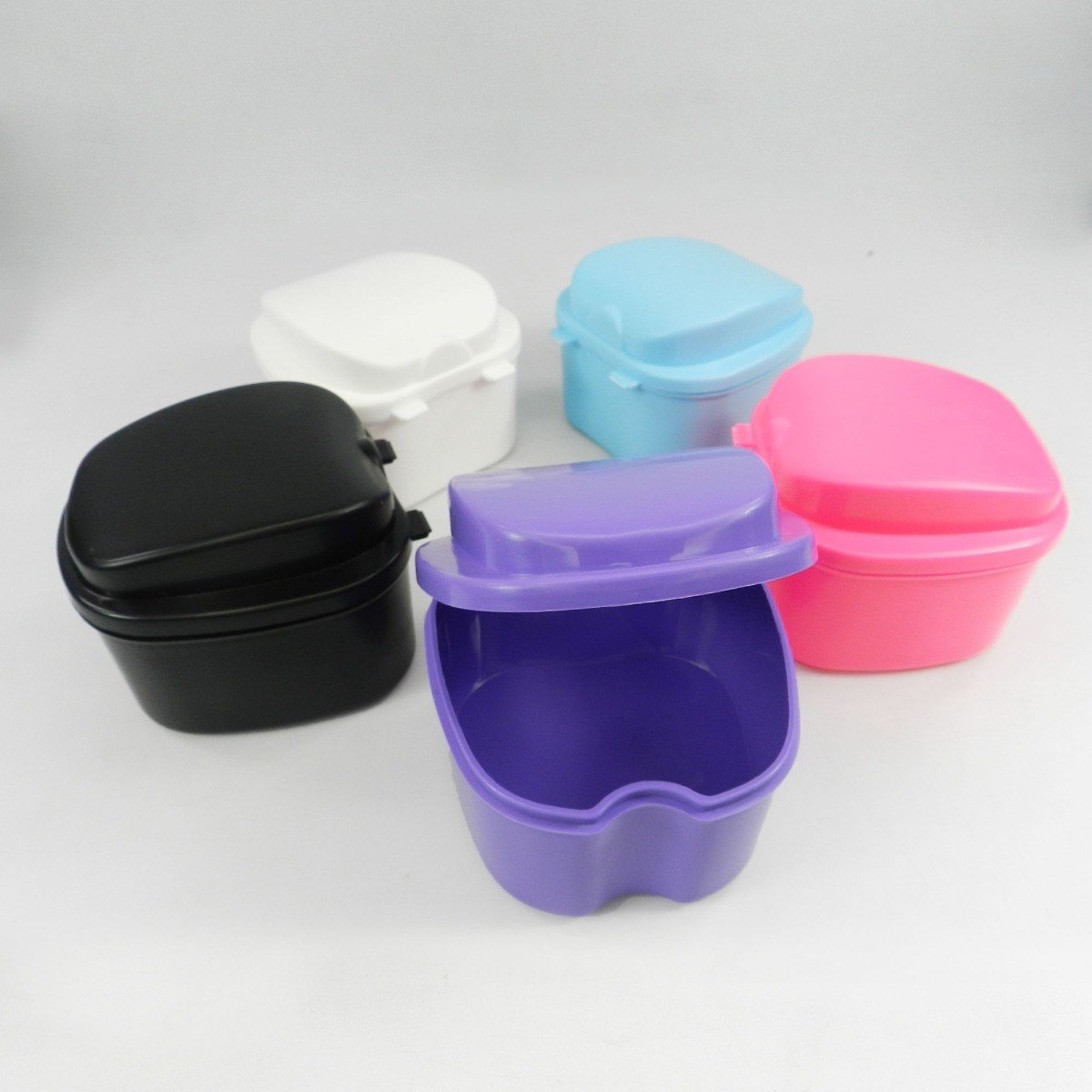 Assorted LD Denture and Retainer Boxes in a 10-pack, compact plastic storage containers for dental prosthetics.