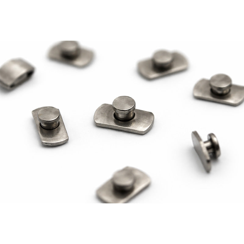 Leone s.p.a weldable lingual buttons with curved design for orthodontic lingual braces, shown in a close-up image.