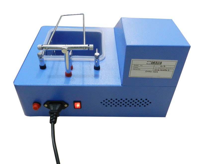 OrthoCare Electro Polisher for dental polishing, displaying a compact electro polishing unit with control buttons and polishing attachments.