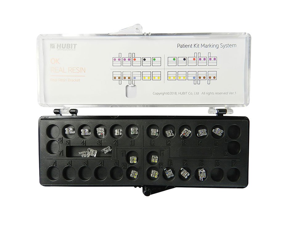 Osstem OK Real Resin Aesthetic Brackets with Metal Slot for orthodontic treatment, shown in a close-up image.