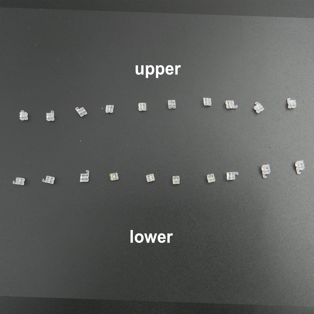 Osstem OK Real Resin with Metal Slot Brackets for aesthetic orthodontic treatment, shown in a pack of 20 brackets by Osstem Orthodontics.