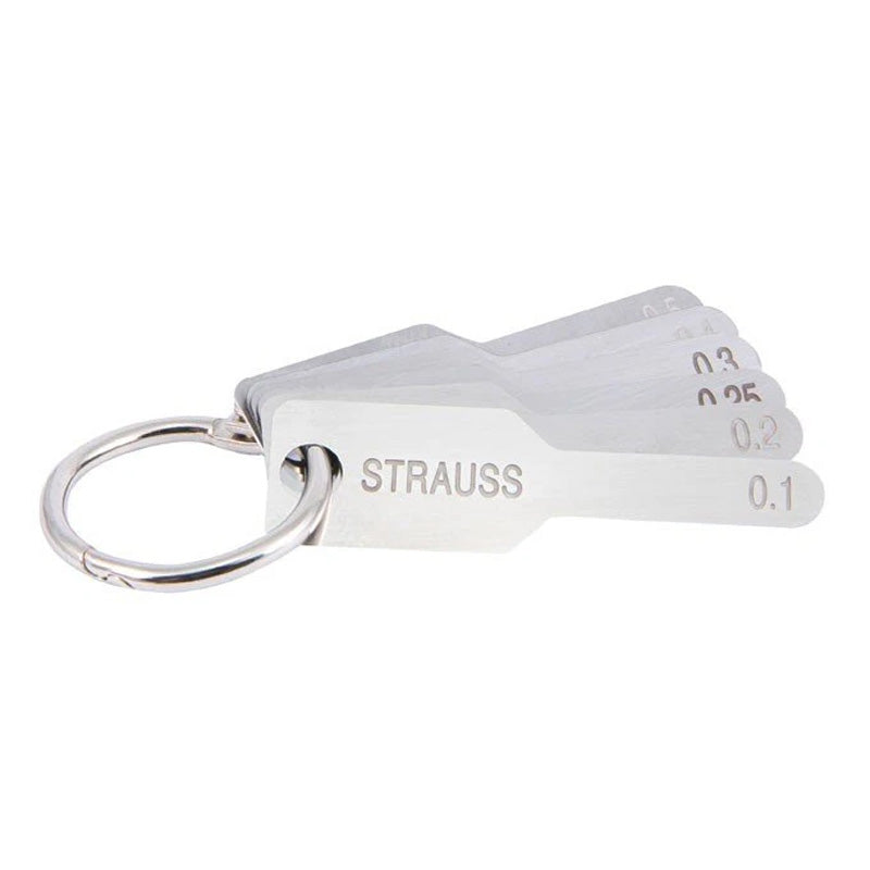 Strauss & Co orthodontic IPR gauge kit with burs for interproximal reduction, shown with various small dental burs and measuring tools.