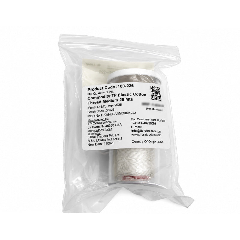 Light-colored TP Orthodontics elastic latex-free cotton thread in a sleeve and thread packaging for orthodontic use